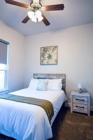 a bedroom with a bed and a chandelier