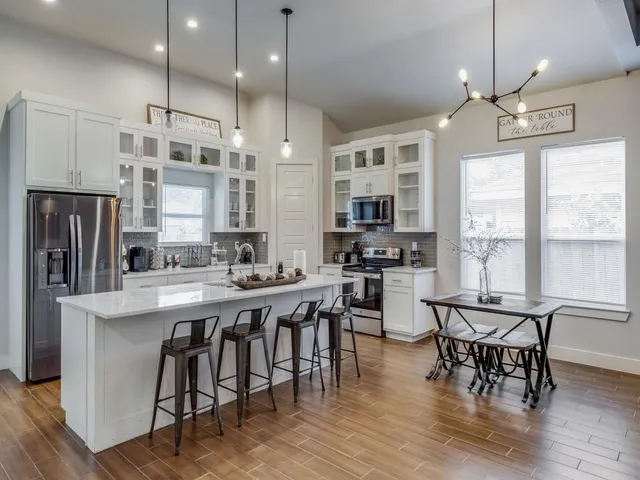 a large kitchen with a table and chairs