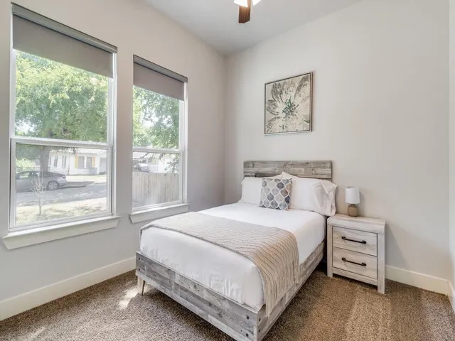 a bedroom with a bed and a window