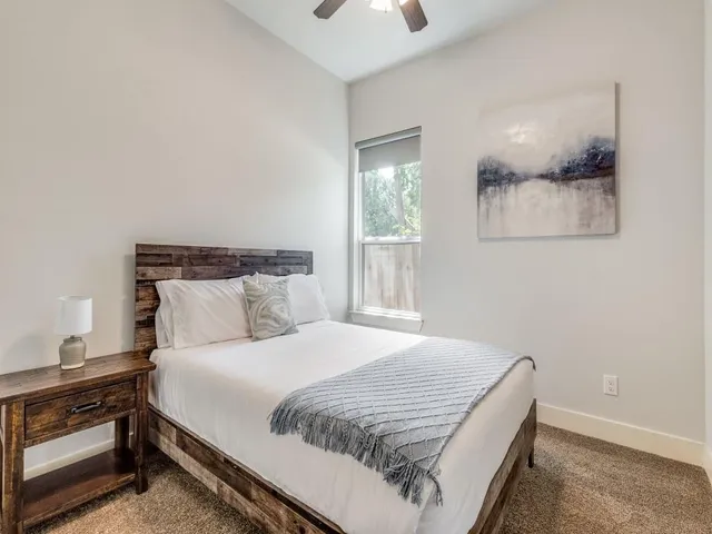 a bedroom with a bed and window