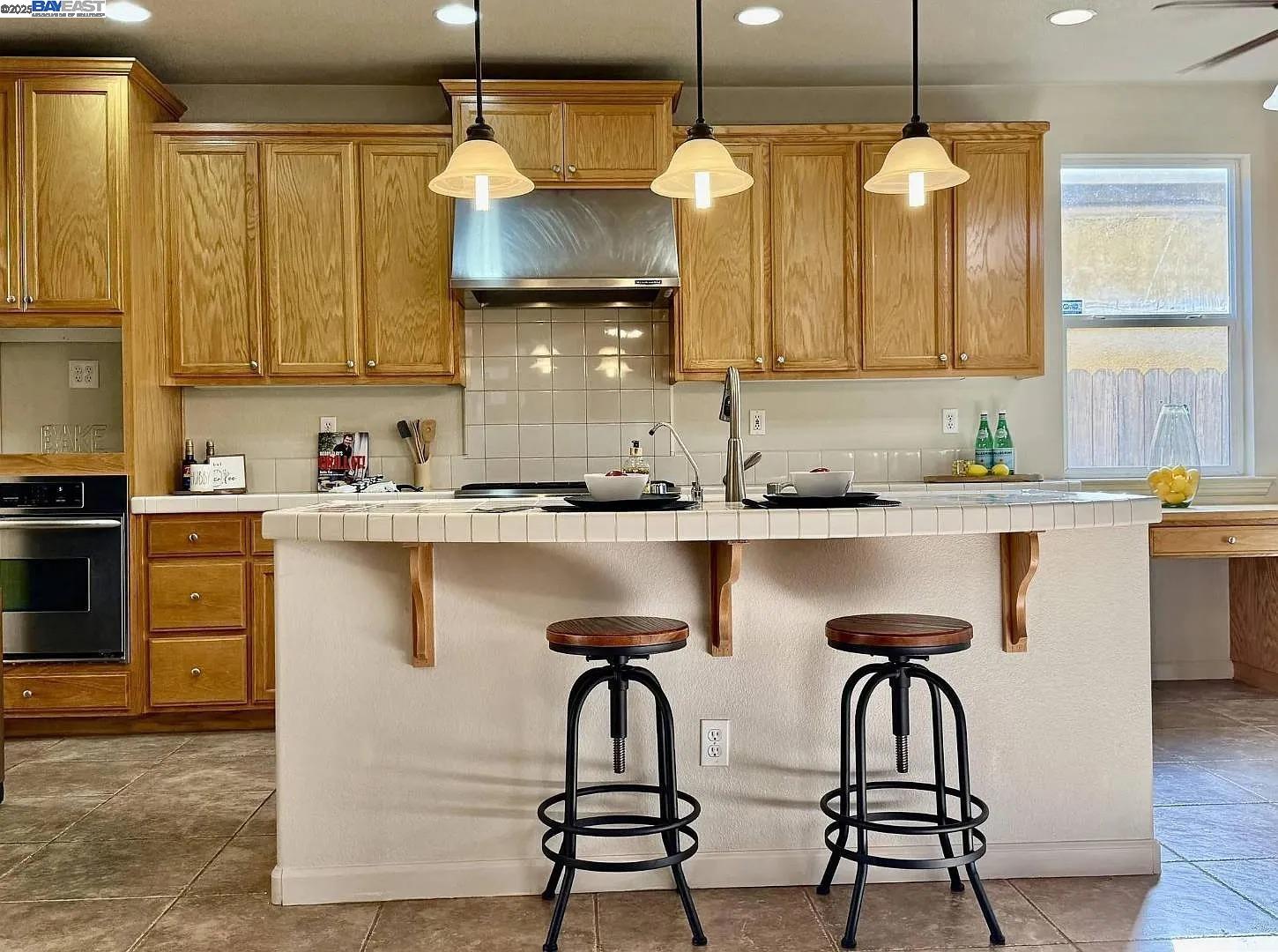 3017 Roslyn Drive Modesto, CA 95355 - Photo 12 of 30 a kitchen with a sink cabinets and window