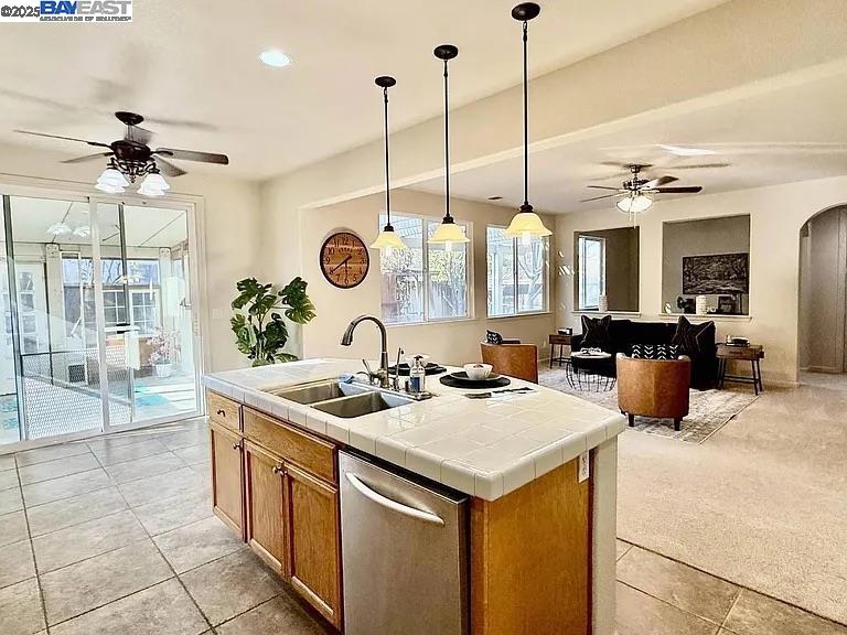 3017 Roslyn Drive Modesto, CA 95355 - Photo 15 of 30 a kitchen with a sink a counter and a view of living room