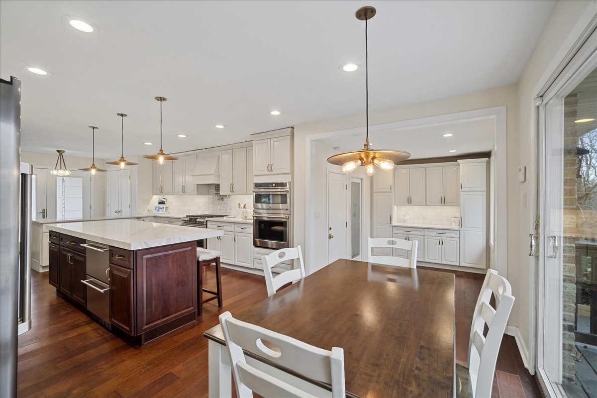 480 Highway 22 Barrington, IL 60010 - Photo 5 of 25 a kitchen with kitchen island a stove a counter top space and a chandelier