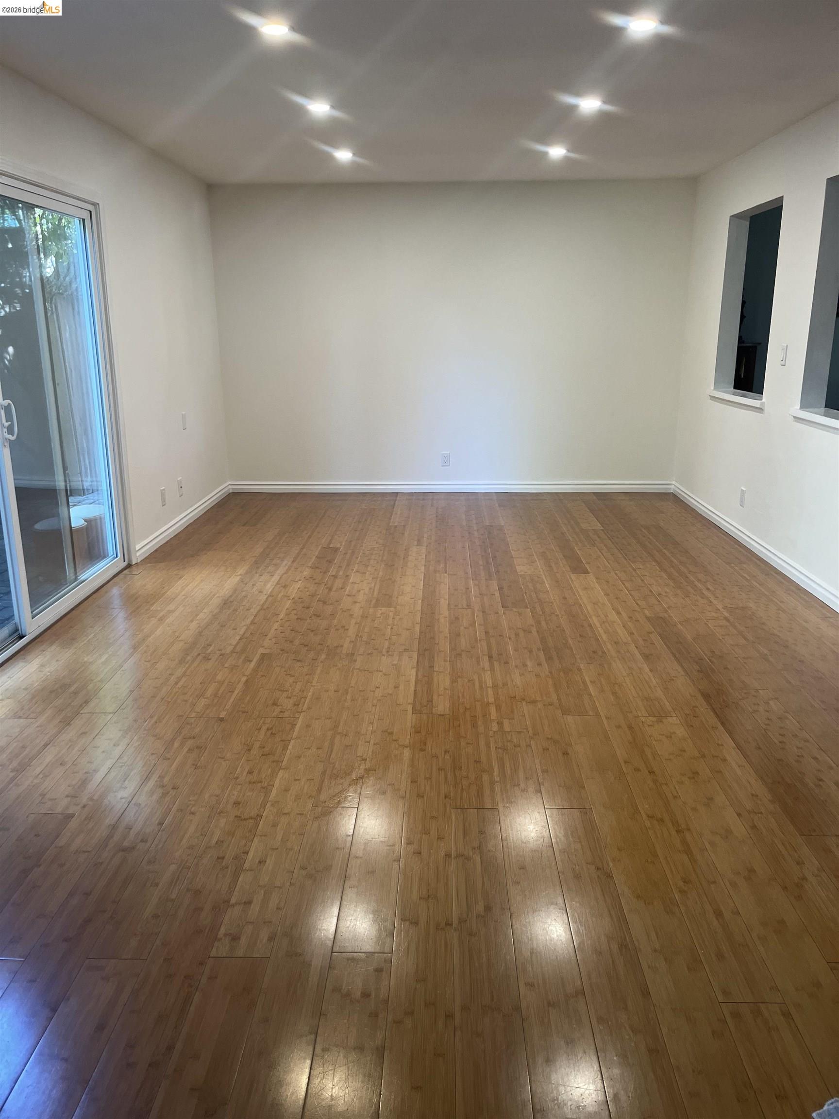 10013 Foxboro Circle San Ramon, CA 94583 - Photo 13 of 39 an empty room with wooden floor and windows