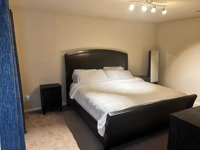 a bedroom with a bed and a lamp