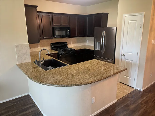 a kitchen with cabinets and stainless steel appliances