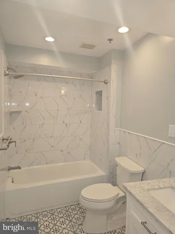 a bathroom with a sink a toilet and a bathtub