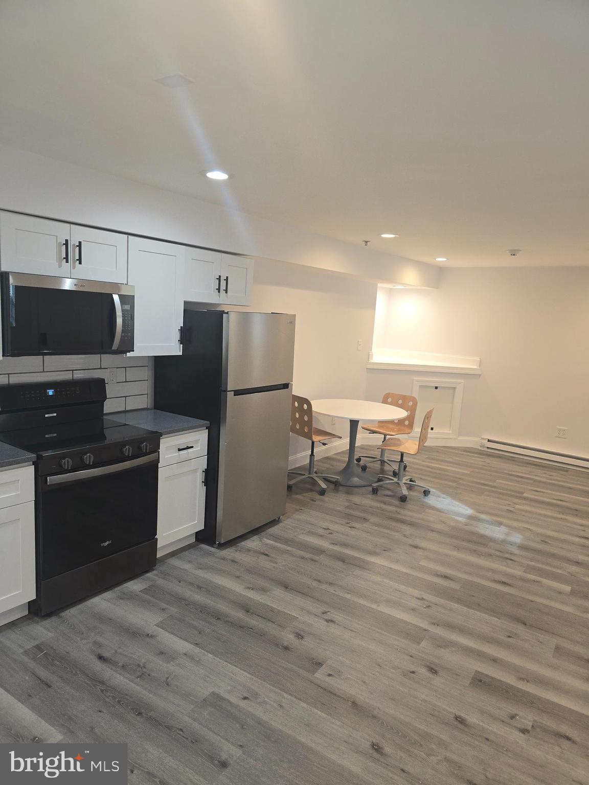 210 Shurs Lane, Unit STUDIO Philadelphia, PA 19128 - Photo 3 of 14 a kitchen with a refrigerator and a stove top oven