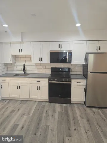 a kitchen with a refrigerator and a stove