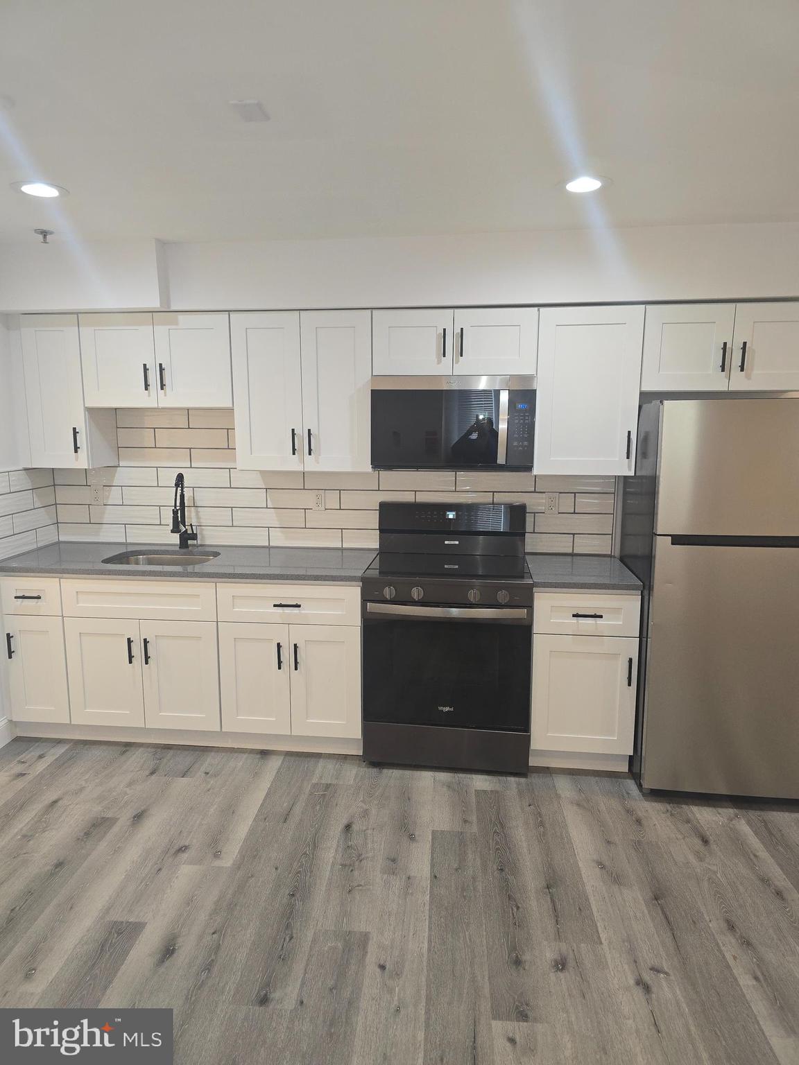 210 Shurs Lane, Unit STUDIO Philadelphia, PA 19128 - Photo 4 of 14 a kitchen with a refrigerator and a stove