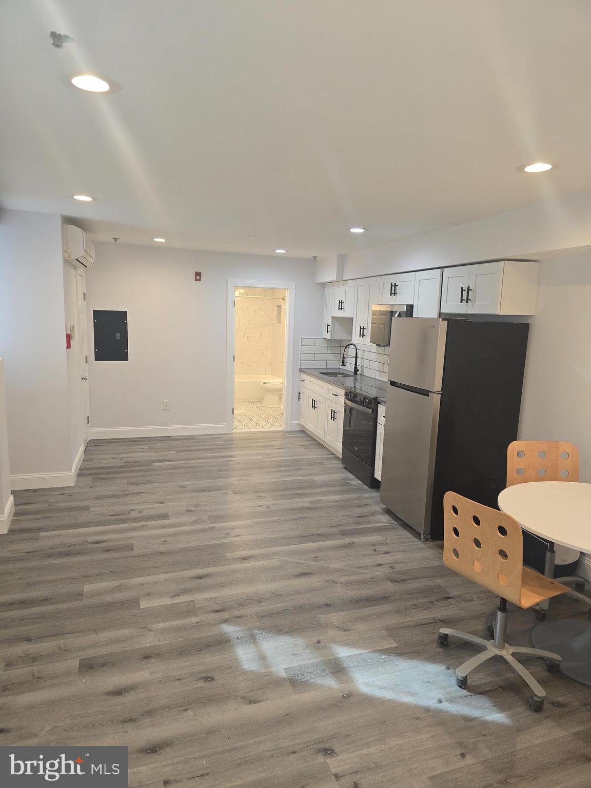 210 Shurs Lane, Unit STUDIO Philadelphia, PA 19128 - Photo 9 of 14 a room with furniture and a wooden floor