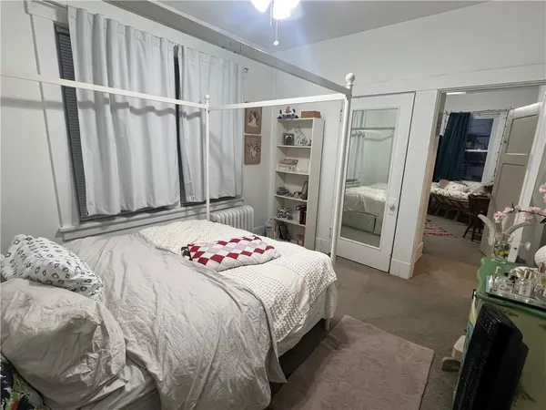 a bedroom with a bed and a flat tv screen