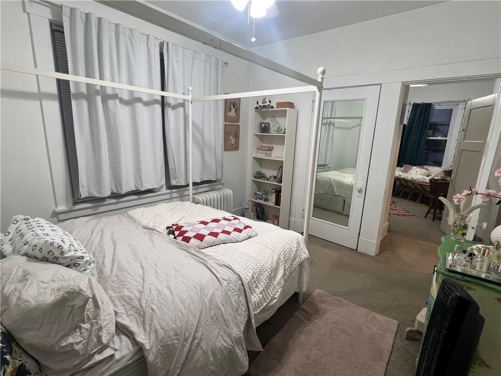 5730 Howe Street, Unit 2 Pittsburgh, PA 15232 - Photo 12 of 21 a bedroom with a bed and a flat tv screen