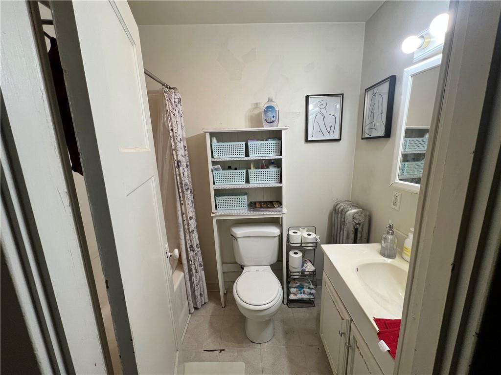 5730 Howe Street, Unit 2 Pittsburgh, PA 15232 - Photo 13 of 21 a white toilet sitting next to a bathroom sink