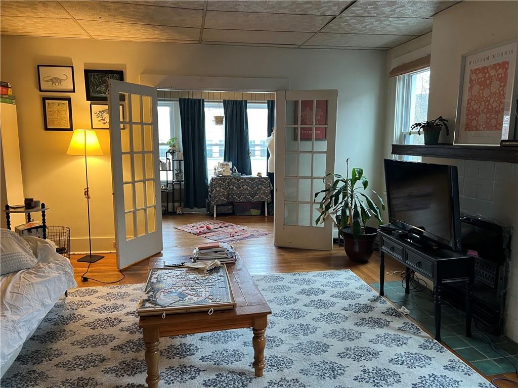 5730 Howe Street, Unit 2 Pittsburgh, PA 15232 - Photo 17 of 21 a living room with furniture a flat screen tv and a floor to ceiling window