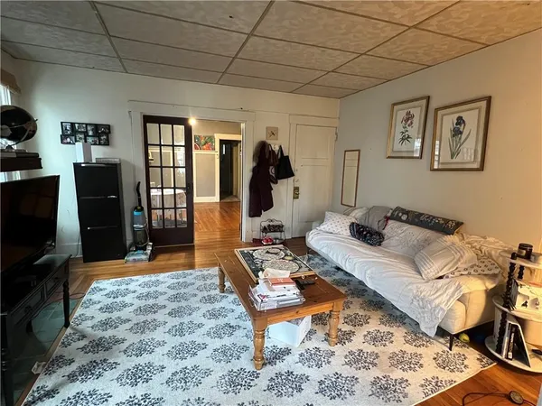 a living room with furniture a rug and a flat screen tv
