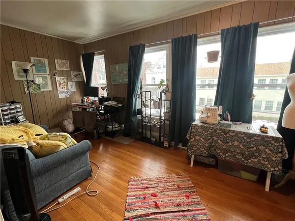 a bedroom with bed couch and window