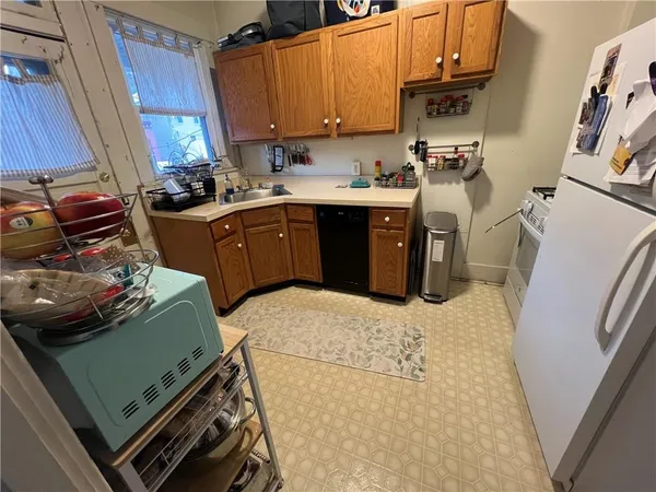 a kitchen with a sink appliances and cabinets