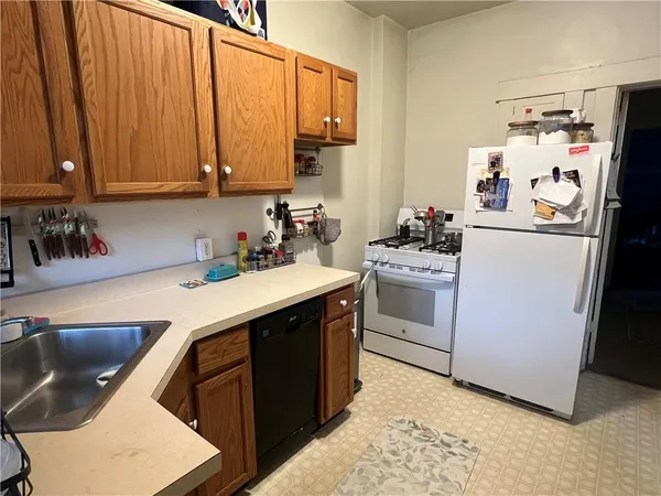 a kitchen with a sink stove and refrigerator