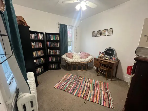 a bedroom with furniture and a book shelf