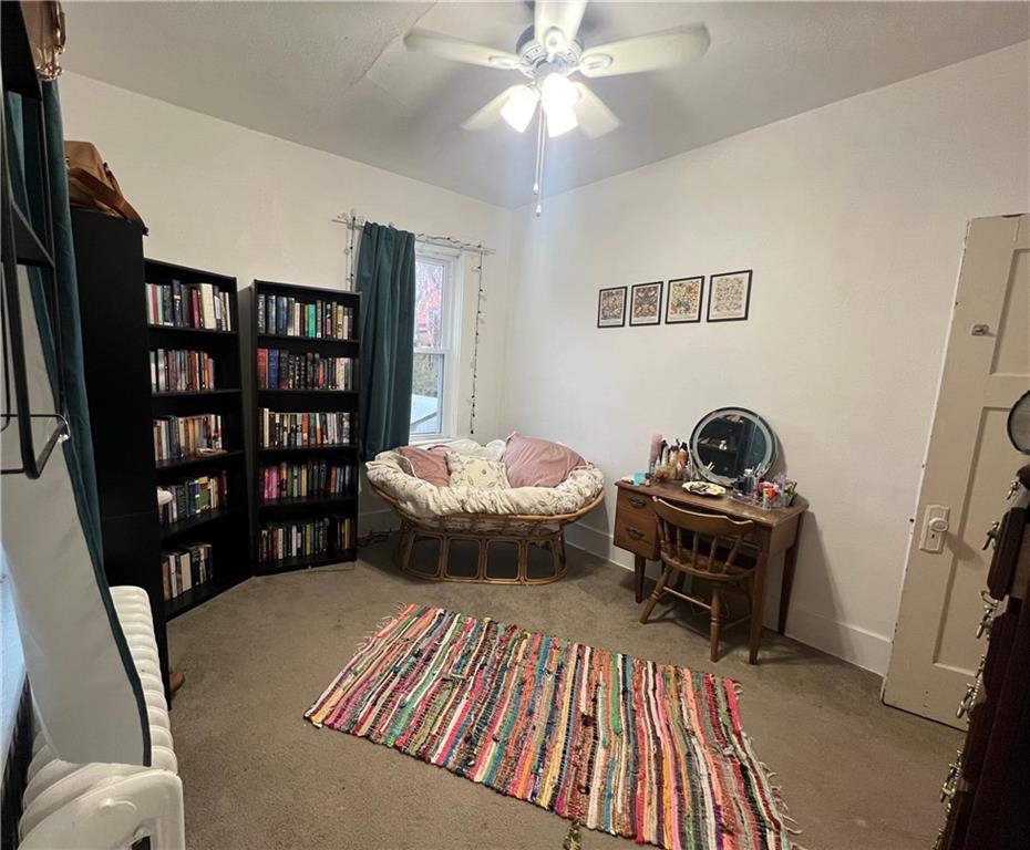 5730 Howe Street, Unit 2 Pittsburgh, PA 15232 - Photo 6 of 21 a bedroom with a bed and a bookshelf