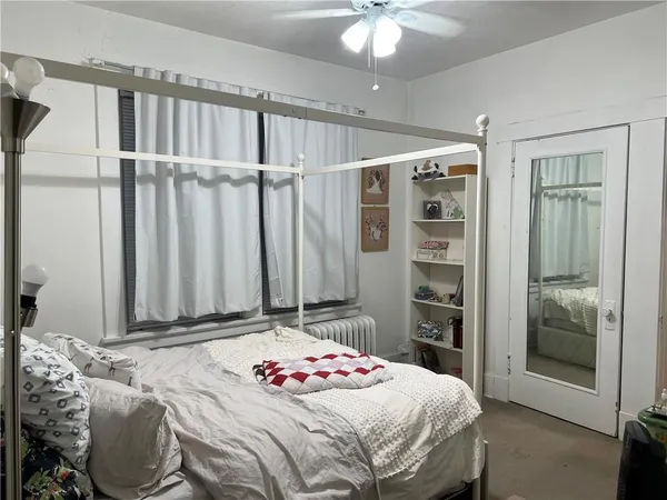 a bedroom with a large bed and a chandelier