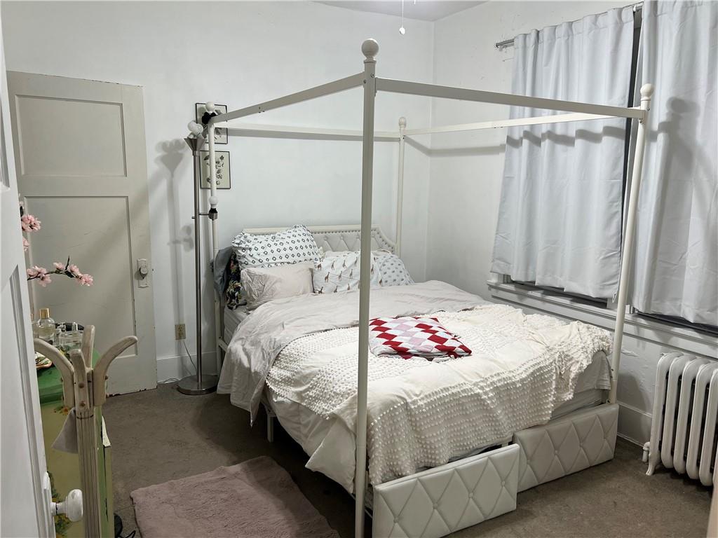 5730 Howe Street, Unit 2 Pittsburgh, PA 15232 - Photo 9 of 21 a bedroom with a bed and a table