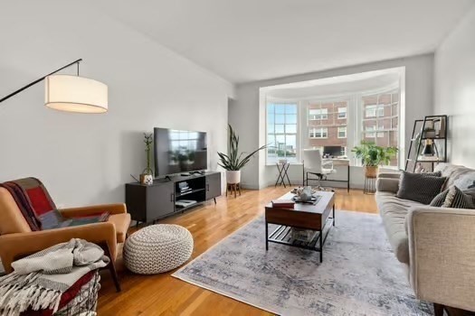 4 Charlesgate East, Unit 604 Boston, MA 02215 - Photo 4 of 20 a living room with furniture and a flat screen tv