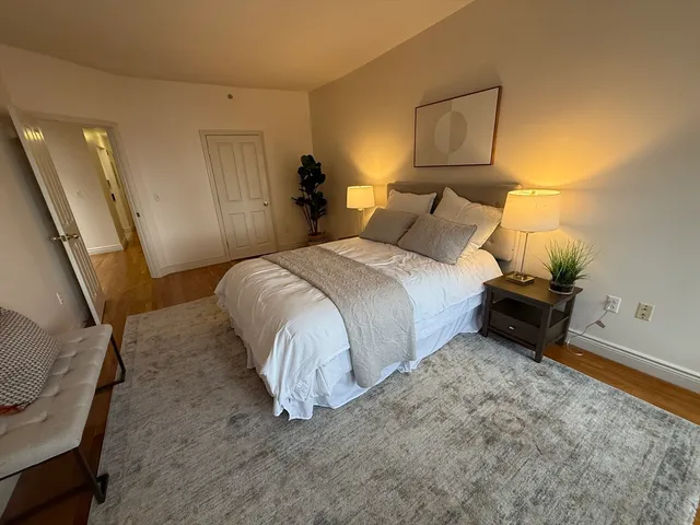 a bed room with a bed and a chair