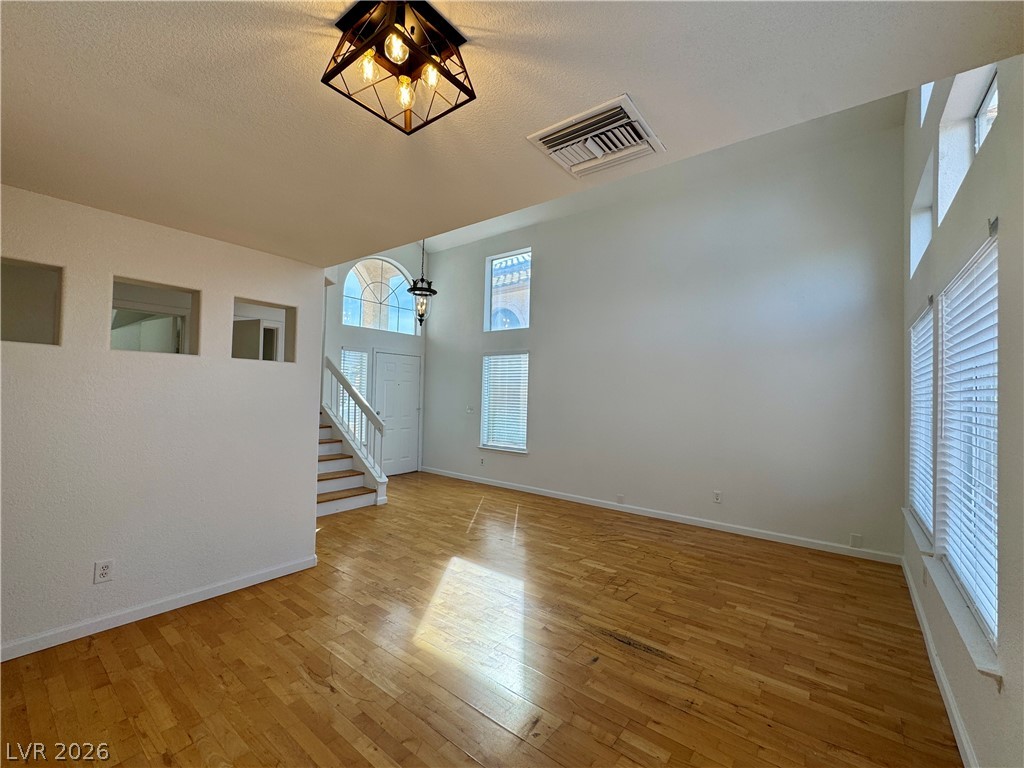 73 Sea Holly Way Henderson, NV 89074 - Photo 47 of 59 Empty room featuring a high ceiling and light wood-style floors