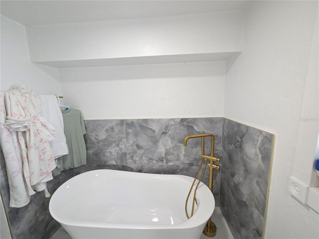 2839 Olympic Street Sarasota, FL 34231 - Photo 21 of 34 a bath tub sitting in a bathroom