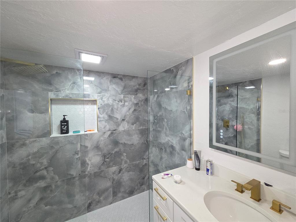 2839 Olympic Street Sarasota, FL 34231 - Photo 22 of 34 a bathroom with a sink double vanity and a mirror