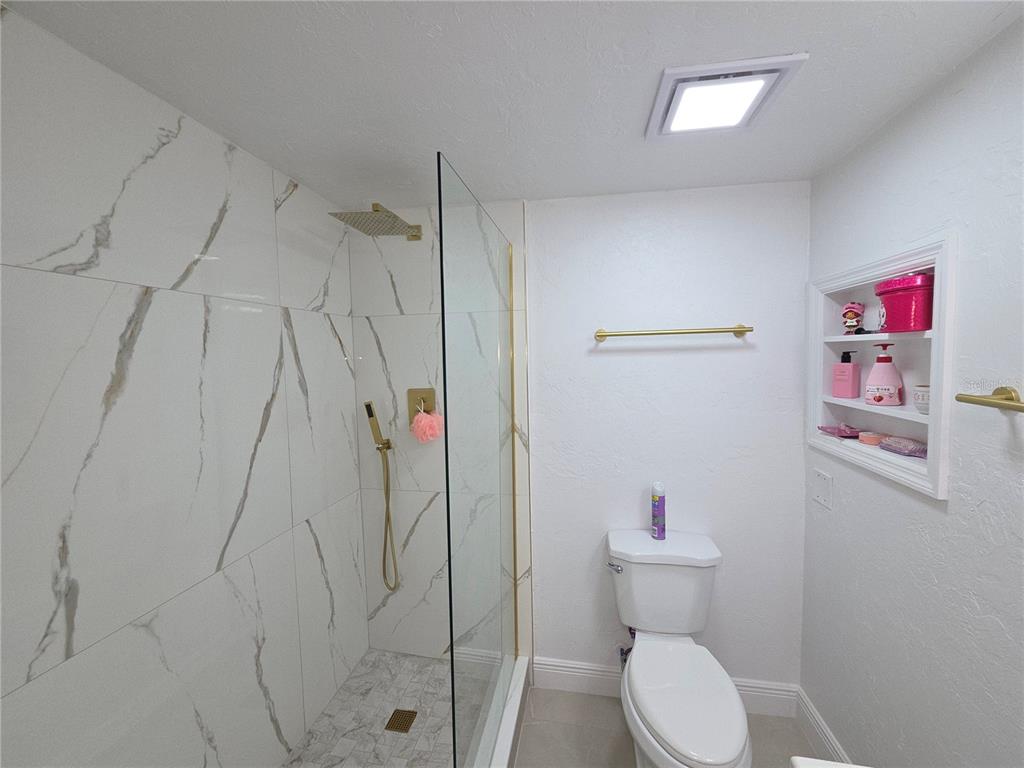 2839 Olympic Street Sarasota, FL 34231 - Photo 26 of 34 a bathroom with a toilet and a shower