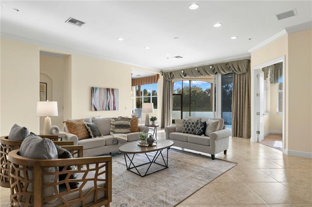 17046 Porta Vecchio Way, Unit 101 Naples, FL 34110 - Photo 1 of 27 a living room with furniture and a large window