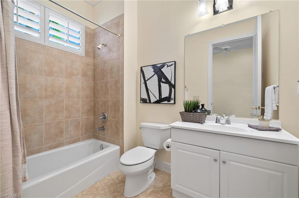 17046 Porta Vecchio Way, Unit 101 Naples, FL 34110 - Photo 14 of 27 a bathroom with a sink a toilet and shower