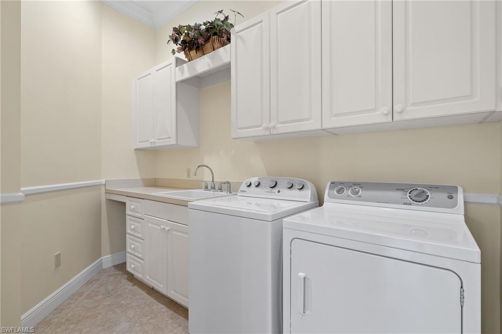 17046 Porta Vecchio Way, Unit 101 Naples, FL 34110 - Photo 15 of 27 a utility room with dryer and washer