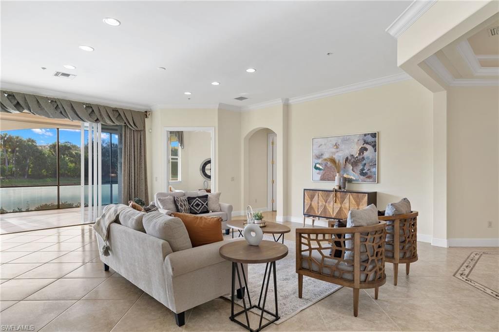 17046 Porta Vecchio Way, Unit 101 Naples, FL 34110 - Photo 16 of 27 a living room with furniture and a large window