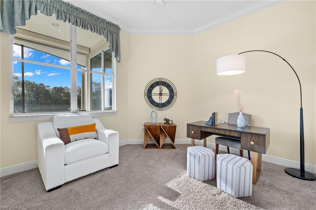 17046 Porta Vecchio Way, Unit 101 Naples, FL 34110 - Photo 17 of 27 a living room with furniture and a window