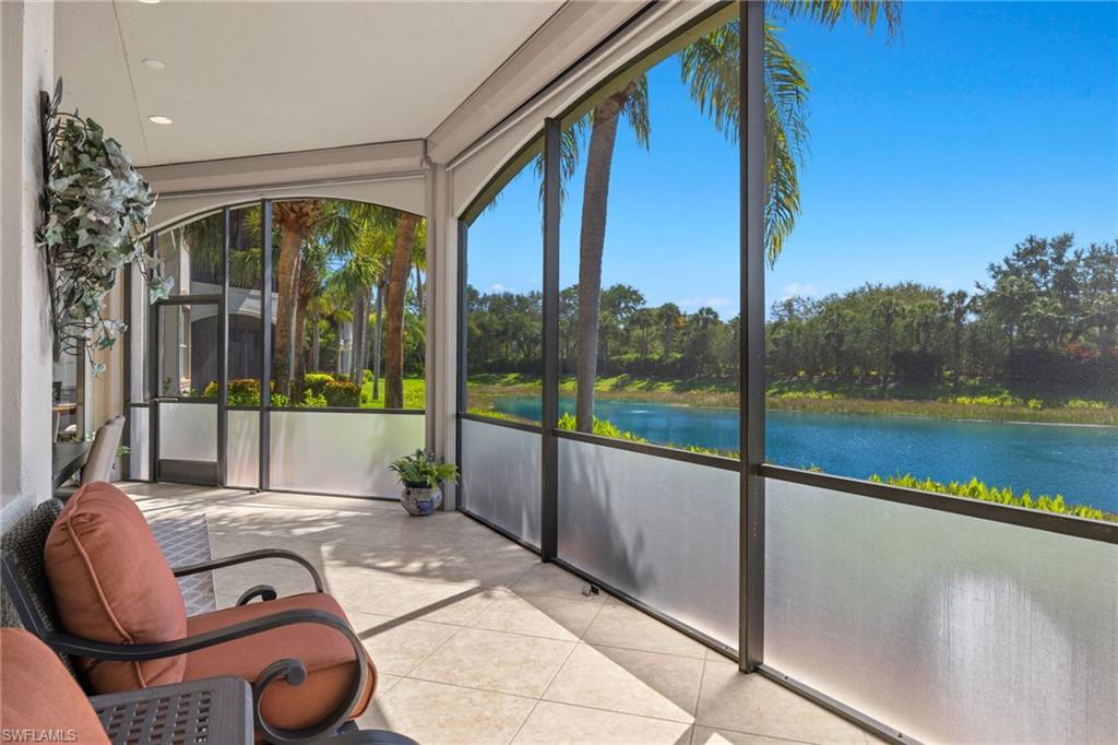 17046 Porta Vecchio Way, Unit 101 Naples, FL 34110 - Photo 19 of 27 a view of swimming pool with a couches and wooden floor