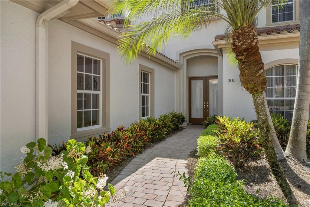 17046 Porta Vecchio Way, Unit 101 Naples, FL 34110 - Photo 20 of 27 front view of a house with a yard