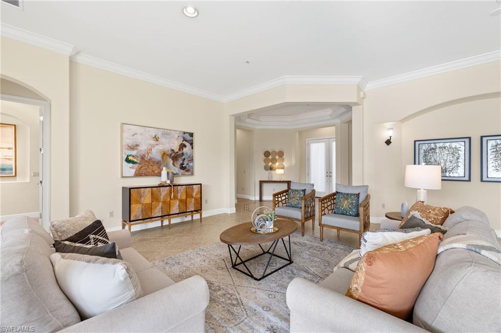 17046 Porta Vecchio Way, Unit 101 Naples, FL 34110 - Photo 2 of 27 a living room with furniture and a flat screen tv