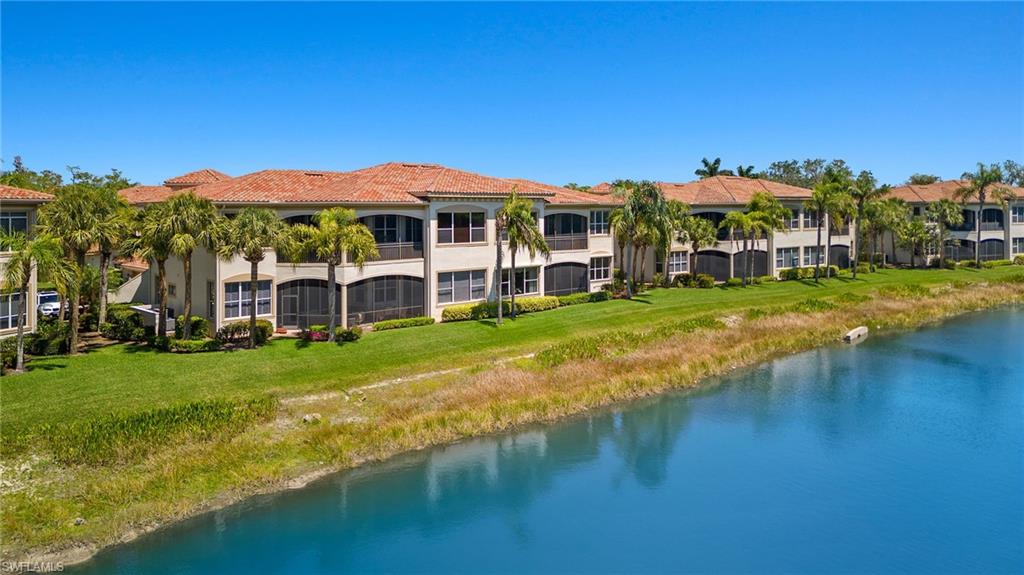 17046 Porta Vecchio Way, Unit 101 Naples, FL 34110 - Photo 25 of 27 a view of a house with a big yard