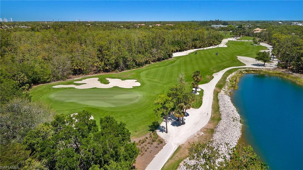 17046 Porta Vecchio Way, Unit 101 Naples, FL 34110 - Photo 26 of 27 a view of a city and mountains in the background