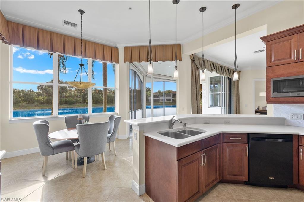 17046 Porta Vecchio Way, Unit 101 Naples, FL 34110 - Photo 3 of 27 a kitchen with a sink a counter top space and a view of living room