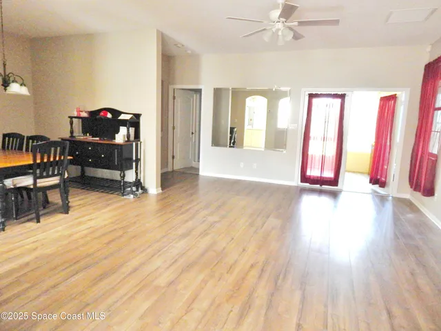 a view of a livingroom with wooden floor and furniture