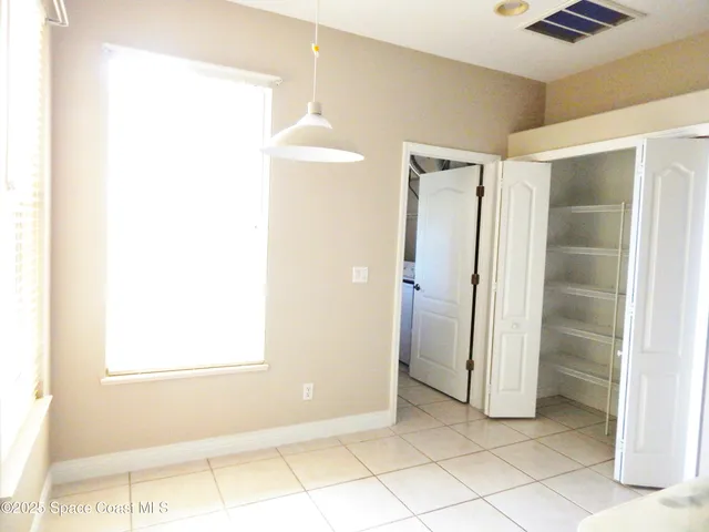 a view of a room with an empty space and a window