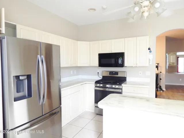 a kitchen with stainless steel appliances a stove a sink and a microwave