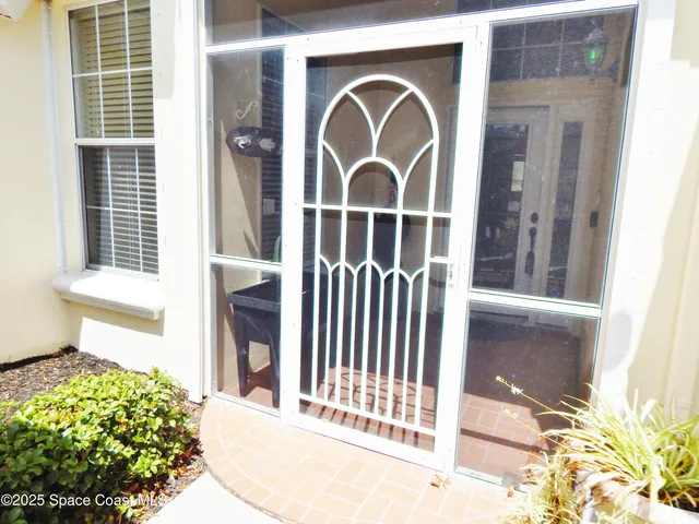 a view of a house with a door and wooden floor