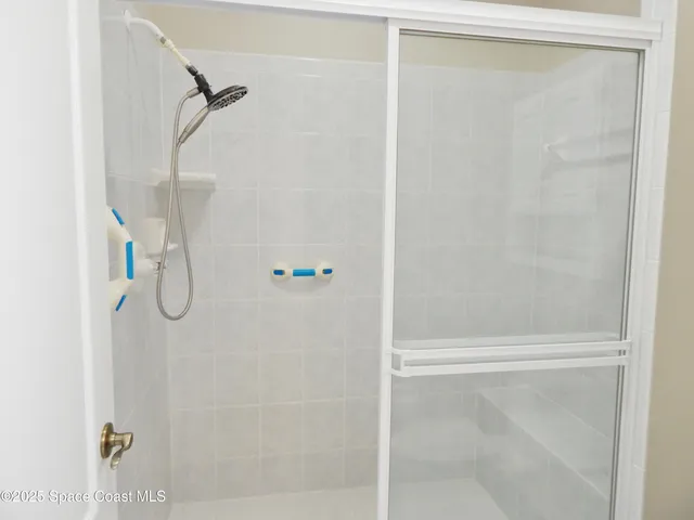 a bathroom with a glass shower door