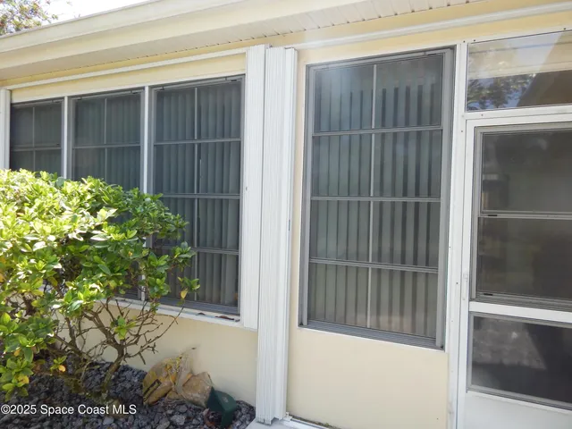 a view of a living room and bathroom with wooden floor